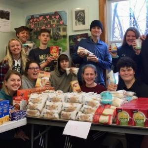 The 10th-grade Trekkers “Team Albatross” helps to organize items for a food pantry last December. (Photo courtesy Trekkers)