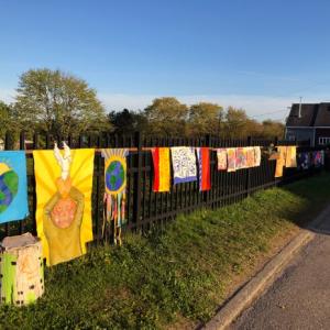 Students are Riley School hang their messages of hope and creating sparks of light amidst these shadowy days on a downtown Rockland fence. (Photo courtesy Riley School)