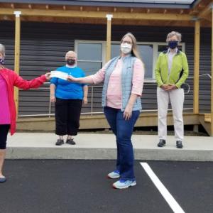 Left to right: Ann Walker, outgoing Nativity Social Ministry Team Leader; Pastor Wendy Anderson; Liz Jenkins, AIO board president; and Elaine Isakson, Nativity’s incoming Social Ministry Team Leader. (Photo courtesy Area Interfaith Outreach)