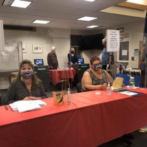 Diane Hamilton, Rockport’s executive assistant, and Cathy Ames-Cruz, poll volunteer, at the Rockport Town Meeting referendum vote, Aug. 18, 2020.