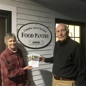 Pauline Johnstone accepts Christmas tree gift certificates from West Bay Rotarian Leamon Scott. (Photo courtesy West Bay Rotary)