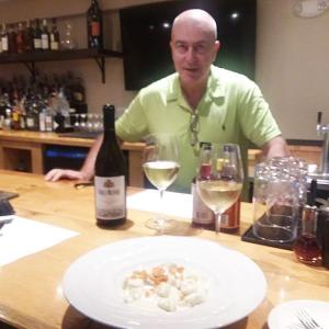 Sante Calandri at the bar over a plate of Gnocci Al 4 Formaggi. Photo by Kay Stephens