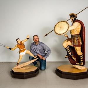 Rockport artist Jon Moro, next to his sculpture of David and nearby his Goliath sculpture. (Photo courtesy Ni Rong)