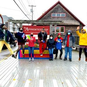 Artists and Project Interns jump for joy at the small outdoor celebration event held in late October. (Photo courtesy RSU 13 Adult & Community Education and Arts in Action)