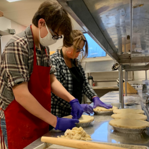 WCTC Culinary Arts Instructor Jackie Boulay assembles Thanksgiving pies with MVHS Senior Caleb Raven. (Photo courtesy Waldo County Technical Center)