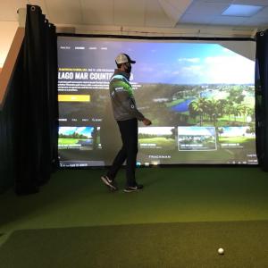 A TrackMan golf simulator representative demonstrates the new simulator at MRC.