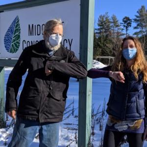 Landowner Jim Doble and Land Protection Specialist Anna Fiedler formalize Doble’s donated Conservation Easement on land in Waldoboro. (Photo courtesy Midcoast Conservancy)