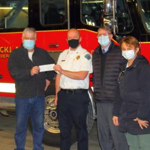 Rockland Rotary’s Melissa Bellew (right) and Butch Worcester (left) presented the $485 check to Fire Chief Chris Whytock (white shirt) and City Manager Tom Luttrell. (Photo courtesy Rockland Fire & EMS)
