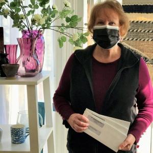 Jeanette Perry, Heavenly Threads Thrift Shop volunteer, is shown holding donation checks that were recently mailed to three local nonprofit organizations. (Photo courtesy Heavenly Threads Thrift Shop)