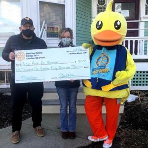 West Bay Rotarian Ray Fink, New Hope for Women Executive Director Rebekah Paredes, and Lucky the Duck. (Photo courtesy West Bay Rotary)