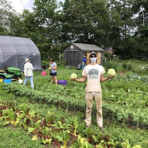 Charlie Cooper, a Teen Ag Crew alumnus, in the garden at Erickson Fields. (Photo by Aaron Englander)