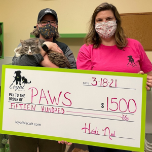 L to R: Shelly Butler (PAWS Animal Adoption Center Executive Director) holds PAWS resident "Big Grey" during Fenway Fund Grant check presentation with Kathy Sigle (Loyal Biscuit Co. Camden-Rockport Manager) Photo courtesy Loyal Biscuit Co.