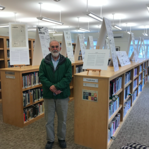 Douglas Coffin stands in front of his exhibit. (Photo courtesy Vose Library and Douglas Coffin)