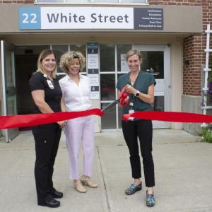 Kendra Emery, DO, (right) cuts the ribbon to mark the opening of PBMC Walk-In Care in Rockland on Tuesday morning, July 6. Looking on are Walk-In Care practice manager Cat Brenner, NCMA, left, and care provider Carrie Ponte, NP, center. (Photo courtesy PBMC)