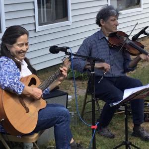 Belfast musicians, Toki Oshima and John Pranio, perform for the “Sing Along and Tap Your Toes” concert series. (Photo by Chrissy Fowler | Belfast Flying Shoes)