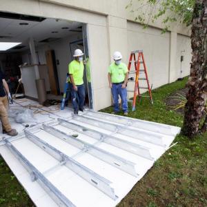 Construction workers cut out a section of exterior wall in the PBMC Radiology and Imaging department in advance of the delivery of the new MRI machine. (Photo courtesy PBMC)