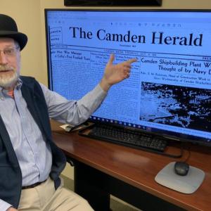 Ken Gross, assistant director of the Camden Public Library, in front of the newly digitized Camden Herald Archives. (Photo courtesy Camden Public Library)
