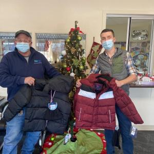 Maine Water employee Paul Farquhar delivers winter coats to a school in Millinocket. (Photo courtesy Maine Water)