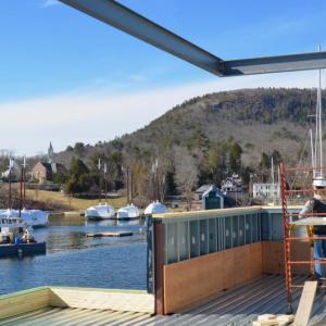 The second floor of the new Salt Wharf Restaurant at Lyman-Morse Boatyard in Camden has views over the harbor and Mount Battie, with open air seating and an awning to protect against the weather.