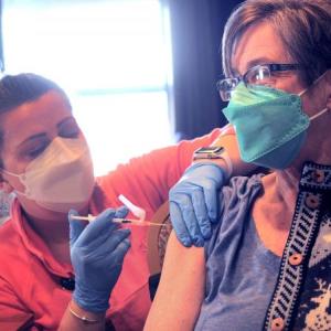 Nurse Shannon Craig-McDaniel administers a free COVID-19 vaccine to Anne Little during a clinic in Rockland. (Photo by Fred J. Field via The Maine Monitor)