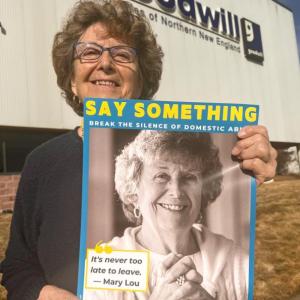 Mary Lou Smith with her Say Something poster, one of 400-plus posters featuring 43 named, Maine survivors of domestic abuse displayed in every Goodwill dressing room and employee break-room in Maine, New Hampshire, and northern Vermont. (Photo courtesy Finding Our Voices)
