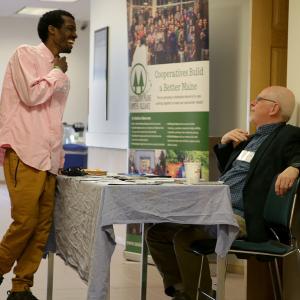 Omar Hassan (left) and Marcel Gagne (right), who work with cooperative businesses across the state, connect at the 2019 P6 conference in Lewiston. (Photo courtesy Cooperative Maine Business Alliance)