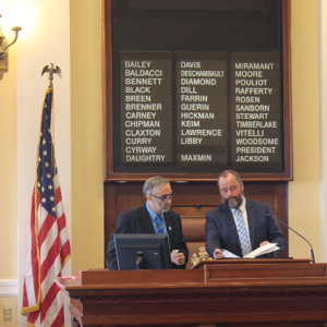 Sen. David Miramant, D-Camden, and Senate Secretary Darek Grant review the calendar as Sen. Miramant presides over the Maine Senate.