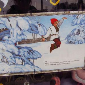 A page of Jan Brett’s illustrated children’s book titled “The Mitten” in the window of a downtown Searsport business. (Photo by Kay Stephens)