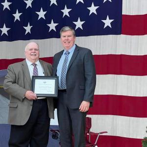 Roger Pomerleau presents the Distinguished Leadership Award to Chuck Hayes for all healthcare workers. (Photo courtesy Chuck Mahaleris)
