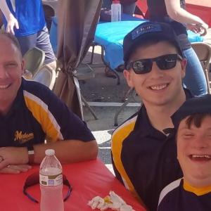 From left are coach Paul Smeltzer, team buddy Aaron Smeltzer and player Myles Frederick