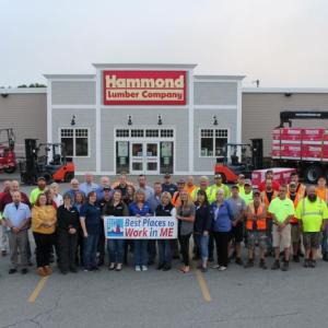 Hammond Lumber Company employees hold a 2022 Best Places to Work in Maine banner. The 2022 Best Places to Work in Maine list is made up of 100 companies in three size categories: 34 small winners (15- 49 U.S. employees), 45 medium winners (50-249 U.S. employees) and 21 large winners (250+ U.S. employees). (Photo courtesy Hammond Lumber Company)