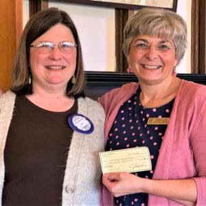 Belfast Rotary Club’s Sue Beemer (left), chair of the Club’s “Evening by the Bay” Harbor Fest gala and auction (left), presents a $10,000 gift to Bonnie Klein of Waldo County Technical Center. (Photo courtesy Belfast Rotary Club)