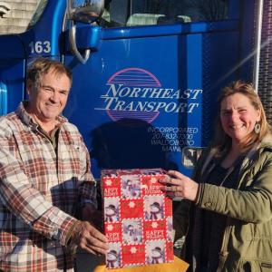 Pictured are Northeast driver Brian Patterson and Angela Bragg of Brighter Heights. (Photo courtesy Northeast Transport)
