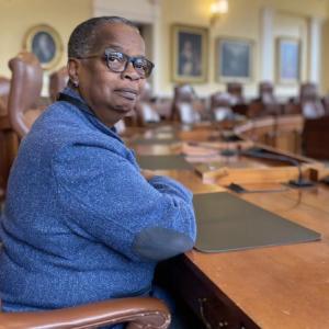 Jill Duson sitting in what will be her chair in the Senate chamber. Photo by Caitlin Andrews/The Maine Monitor.