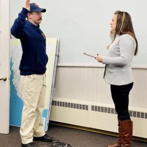 Jackson Winslow is sworn in as Belfast firefighter/EMT Feb. 8 by Belfast City Clerk Amy Bradford. (Photo courtesy City of Belfast)