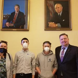AmeriCorps members from left to right: Molly Thibault, Jeremiah King and Zachariah Dewey with Representative Nate Wadsworth while leading a 7th Grade field trip from the I KNOW ME program to the State House last year. (Photo courtesy Game Loft/I Know ME)