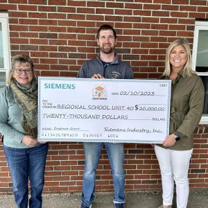 Avae Traina (right) delivered a check on behalf of Siemens to Linda Pease (left), principal of Medomak Valley High School and Ryan McNelly (middle), science teacher at MVH. (Photo courtesy