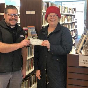 Ann Filley presents Ben Blackmon with a check for $10,000. (Photo courtesy Rockport Public Library)