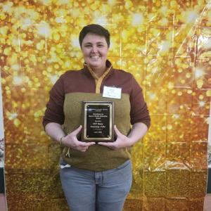 Katie Lutts poses with Community Pillar Award. (Photo courtesy OUT Maine)