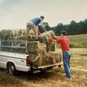 Overloading the old truck with hay bales. (Photo by Diane O’Brien) Haying
