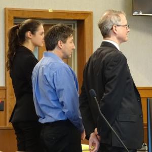 Matthew Pendleton stands with Attorney Chris MacLean and co-counsel at his April 3, arraignment. (photo by Erica Thoms)