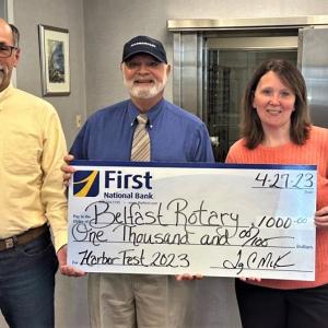 First National Bank presented a $1,000 charitable gift check to Belfast Rotary Club in support of the
August 2023 Belfast Harbor Fest. The bank is a “Ship Owner” sponsor of the event, sponsor of both
the August 19 Harbor Fest “Bug Run” 5K road race and a Harbor Fest National Boatbuilding
Challenge team. Left to right are Edward Varney of First National Bank, Mickey Sirota from Belfast
Rotary Club, and Michelle MacKay of First National Bank. (Photo courtesy First National Bank)