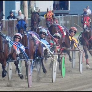 Horses race around the oval at the Union Fair Grounds on Thursday as their jockeys watch for their chance to get ahead. (2015 photo by Chris Wolf)