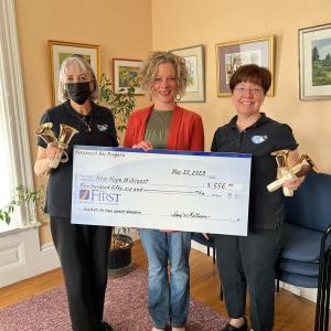 Presenting the check are Penobscot Bay Ringers' representatives Leigh Smith, founder and corresponding secretary (left) and Amy Rollins, artistic director (right), to New Hope Midcoast Executive Director, Rebekah Paredes (center). (Photo courtesy Penobscot Bay Ringers)
