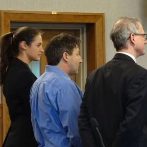 Matthew Pendleton (center) stands with Attorney Christopher MacLean (right) and co-counsel (left) at his Jan. 10 arraignment. (photo by Erica Thoms)