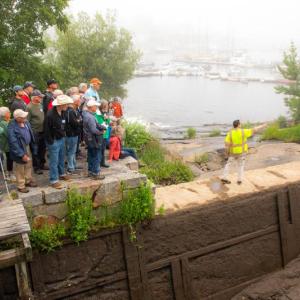 Camden Public Works Director Dave St. Laurent talks with the 70 citizens who toured the Megunticook River and its dams June 27 as part of an ongoing educational effort of the watershed hosted by the municipal Megunticook River Citizens Advisory Committee. (Photo courtesy Lauren Caffe/FB Environmental Associates)