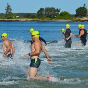 Swimmers enter the water at Pemaquid Beach at the start of the 2019 Pemaquid Beach Triathlon. (Photo courtesy Coastal Rivers Conservation Trust)