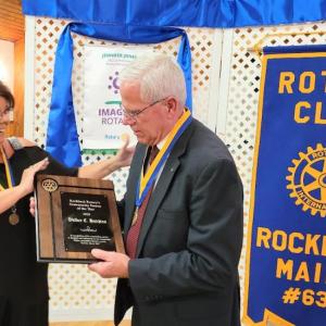 Tena Wallace presents Walker C. Hutchins with a plaque. (Photo courtesy Rockland Rotary)