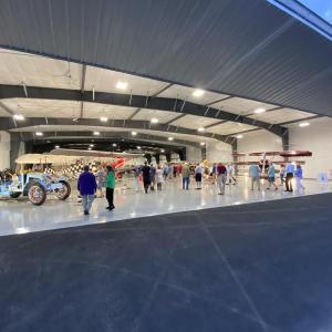 Guests of the Owls Head Transportation Museum gather inside the new workshop hangar. (Photo by by Louis Bettcher)