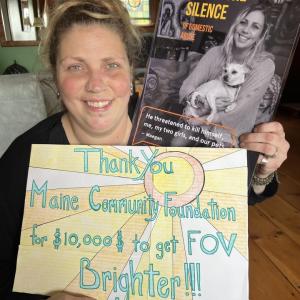 Maegan Graslie is an artist and UMA student in Ellsworth. She is also one of 45 Maine survivors on the Finding Our Voices domestic abuse-awareness posters and bookmarks that have been posted and distributed all across Maine, Here she is with her poster and a Thank You card she created for the Maine Community Foundation. (Photo by Patrisha McLean)